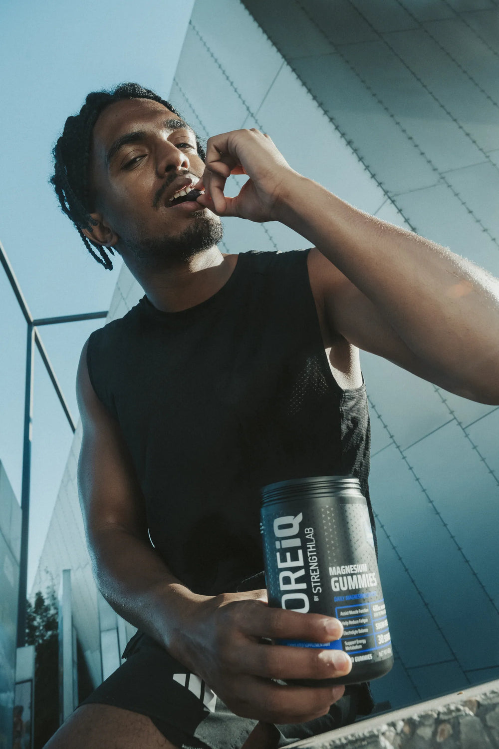 Athlete eating a CoreIQ magnesium gummy, jar in hand