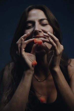 Woman eating CoreIQ creatine gummies