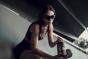 Woman taking a CoreIQ creatine gummy from the jar