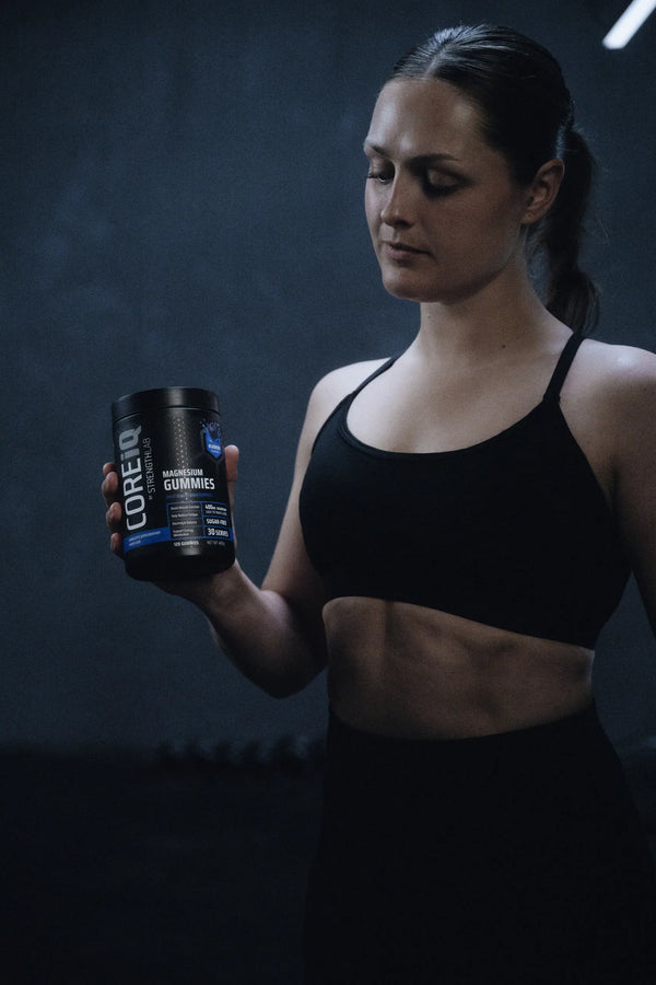 Woman holding a CoreIQ Magnesium Gummies jar