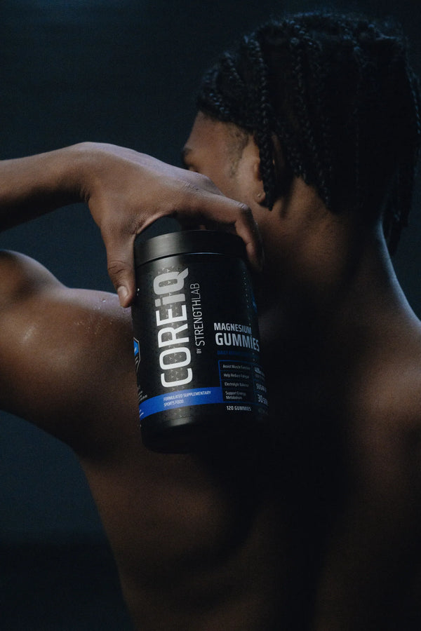 CoreIQ Magnesium Gummies jar held on the shoulder
