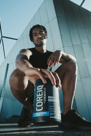 Athlete crouching with a CoreIQ Magnesium Gummies jar