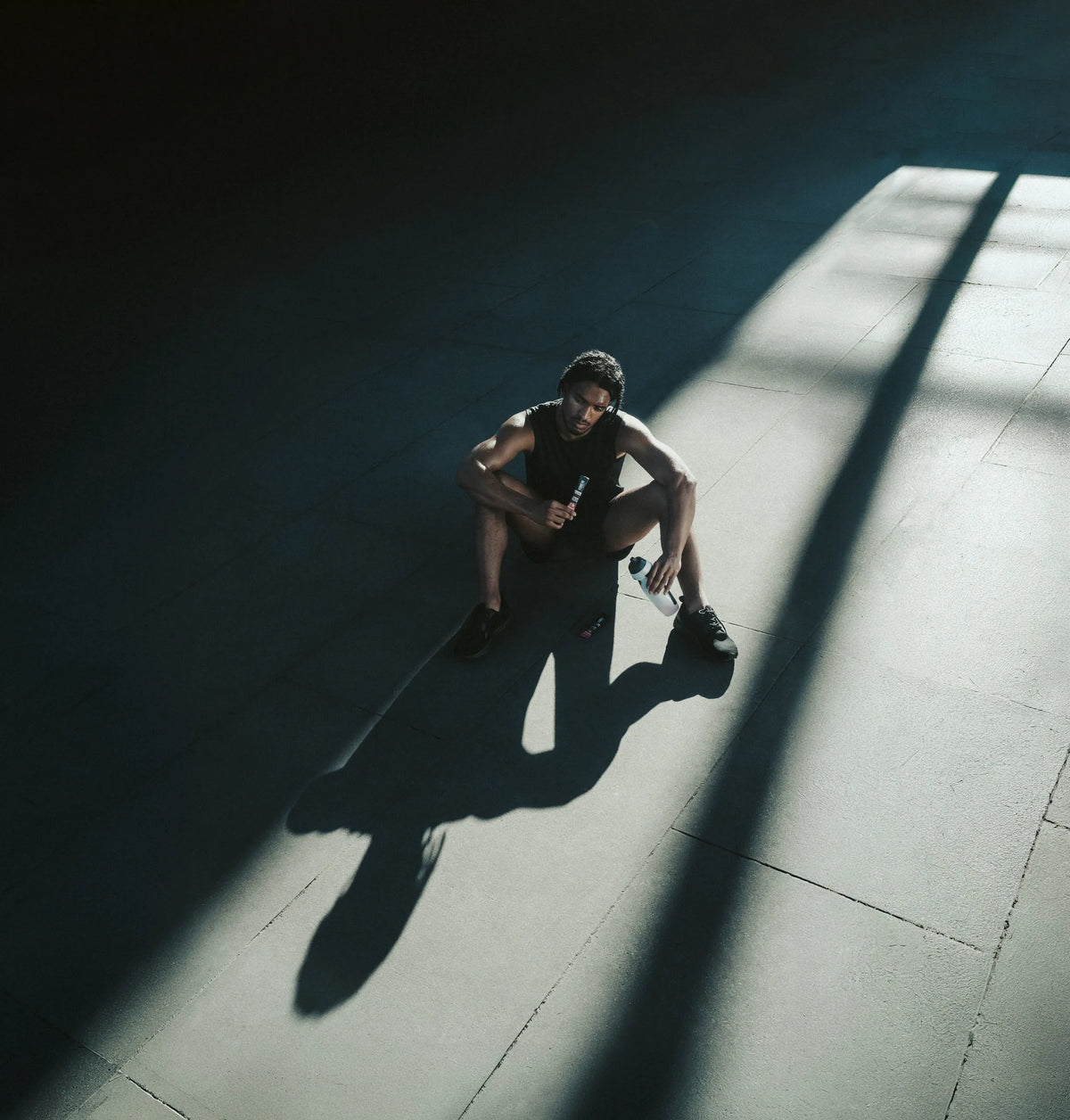Athlete resting in a shaft of light after training