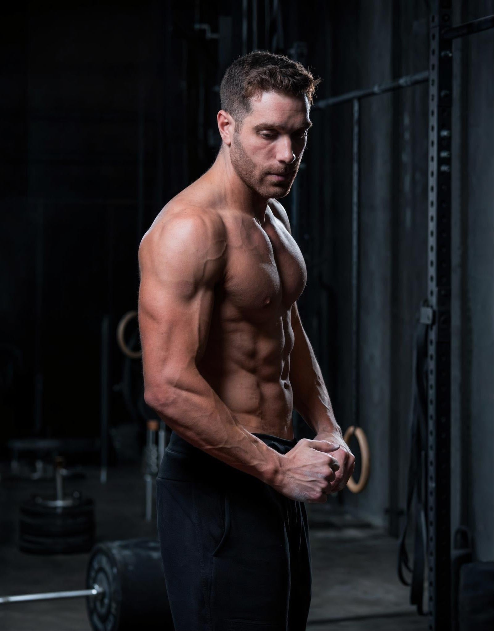 Muscular man posing in a gym setting