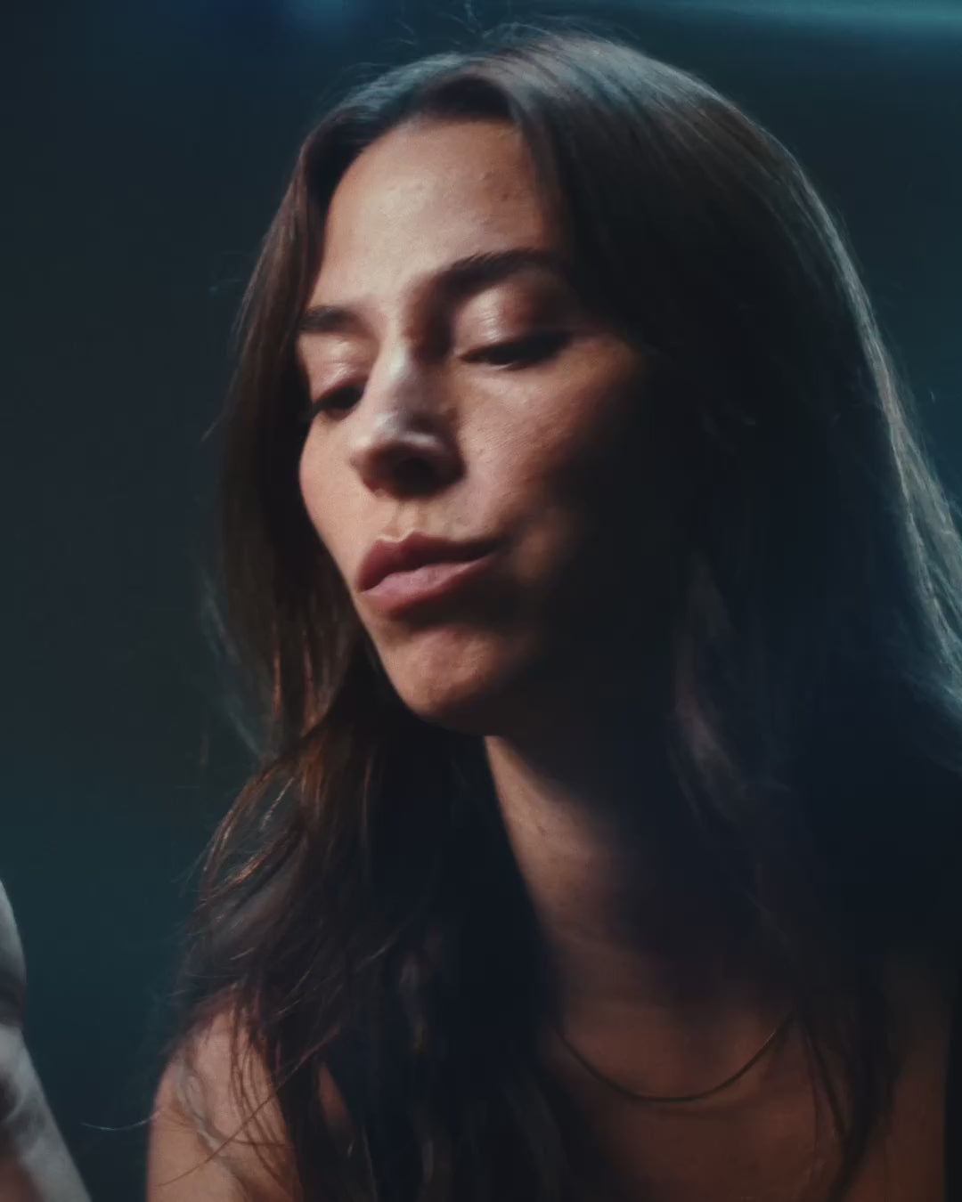 Woman eating a CoreIQ magnesium gummy