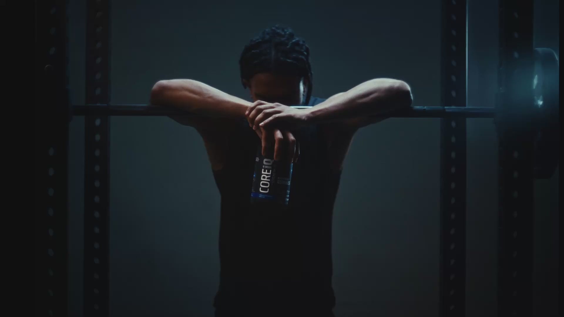 Athlete at a barbell with a CoreIQ Magnesium Gummies jar