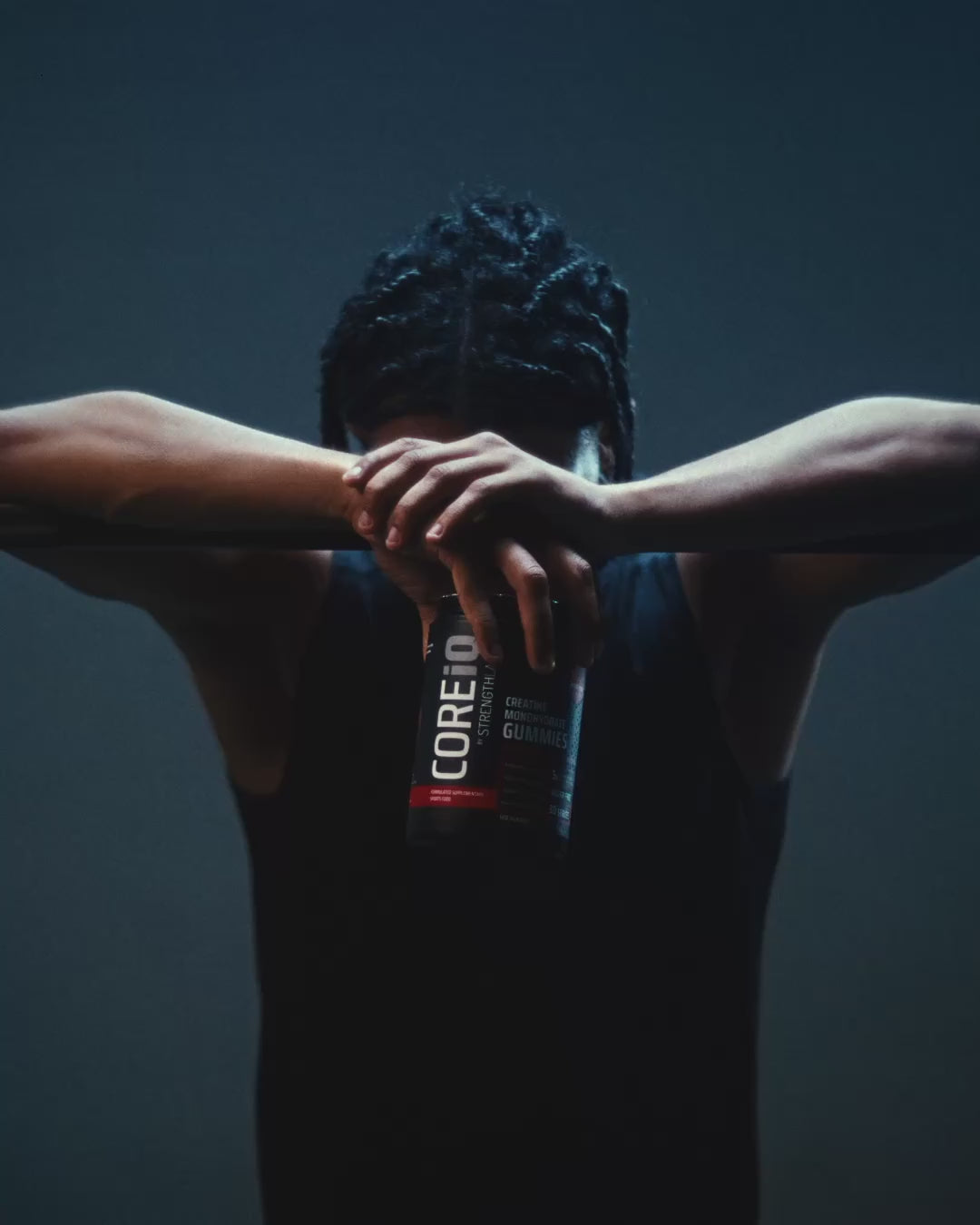 Athlete at a barbell with a CoreIQ Creatine Gummies jar