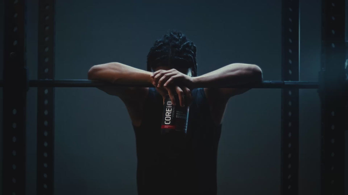 Athlete at a barbell with a CoreIQ Creatine Gummies jar