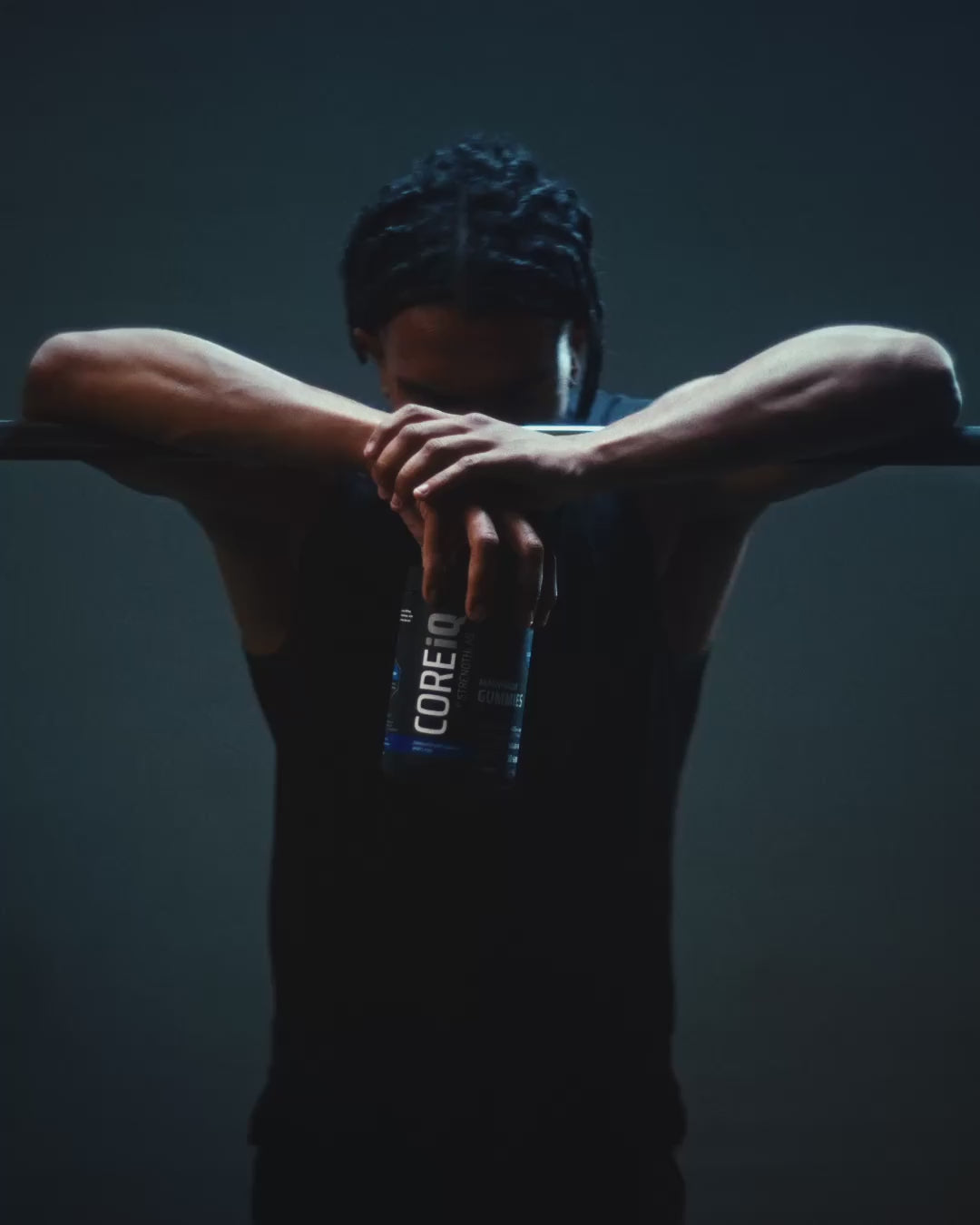 Athlete at a barbell with a CoreIQ Magnesium Gummies jar